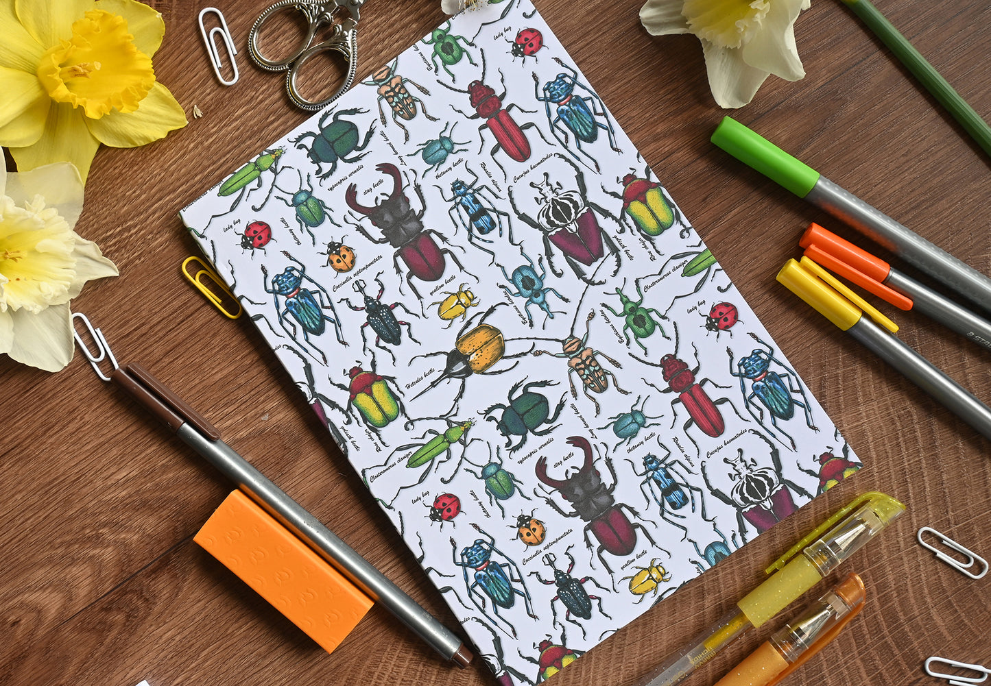 photo of hand-made notebook with hand-painted Beetles pattern print on the cover