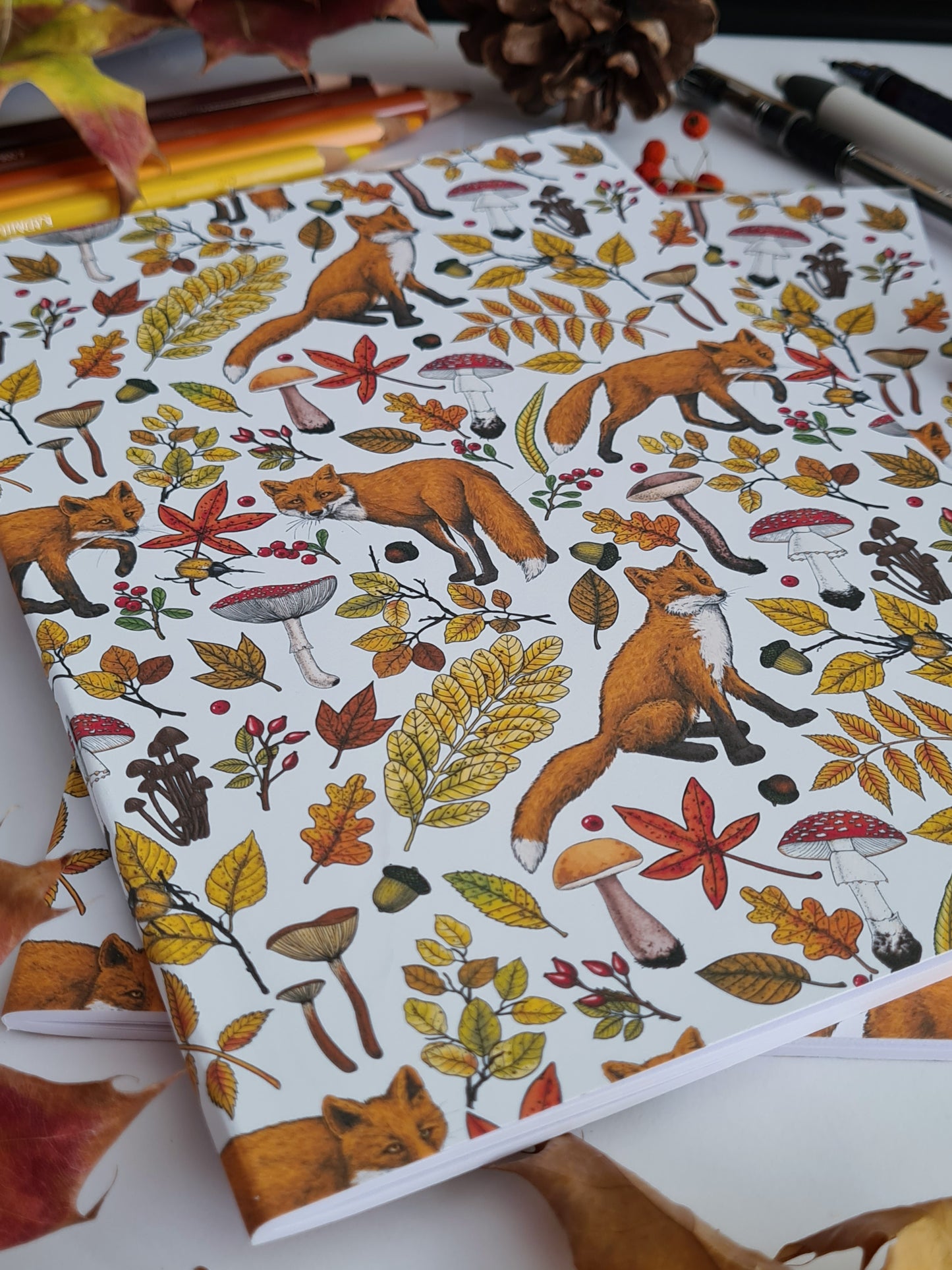 photo of hand-made notebook with hand-painted Autumn Foxes pattern print on the cover
