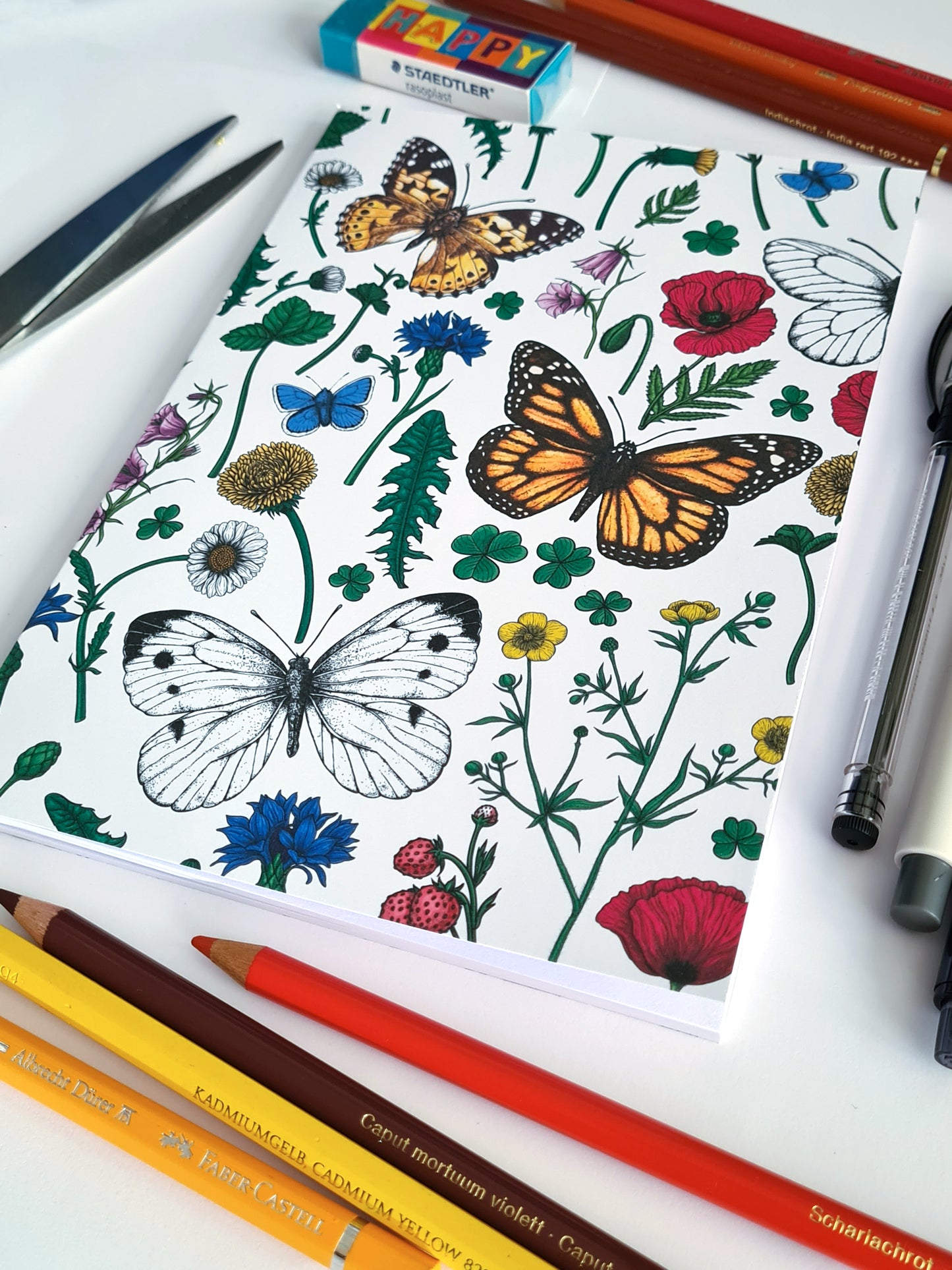 photo of hand-made notebook with hand-painted Wildflowers and butterflies pattern print on the cover