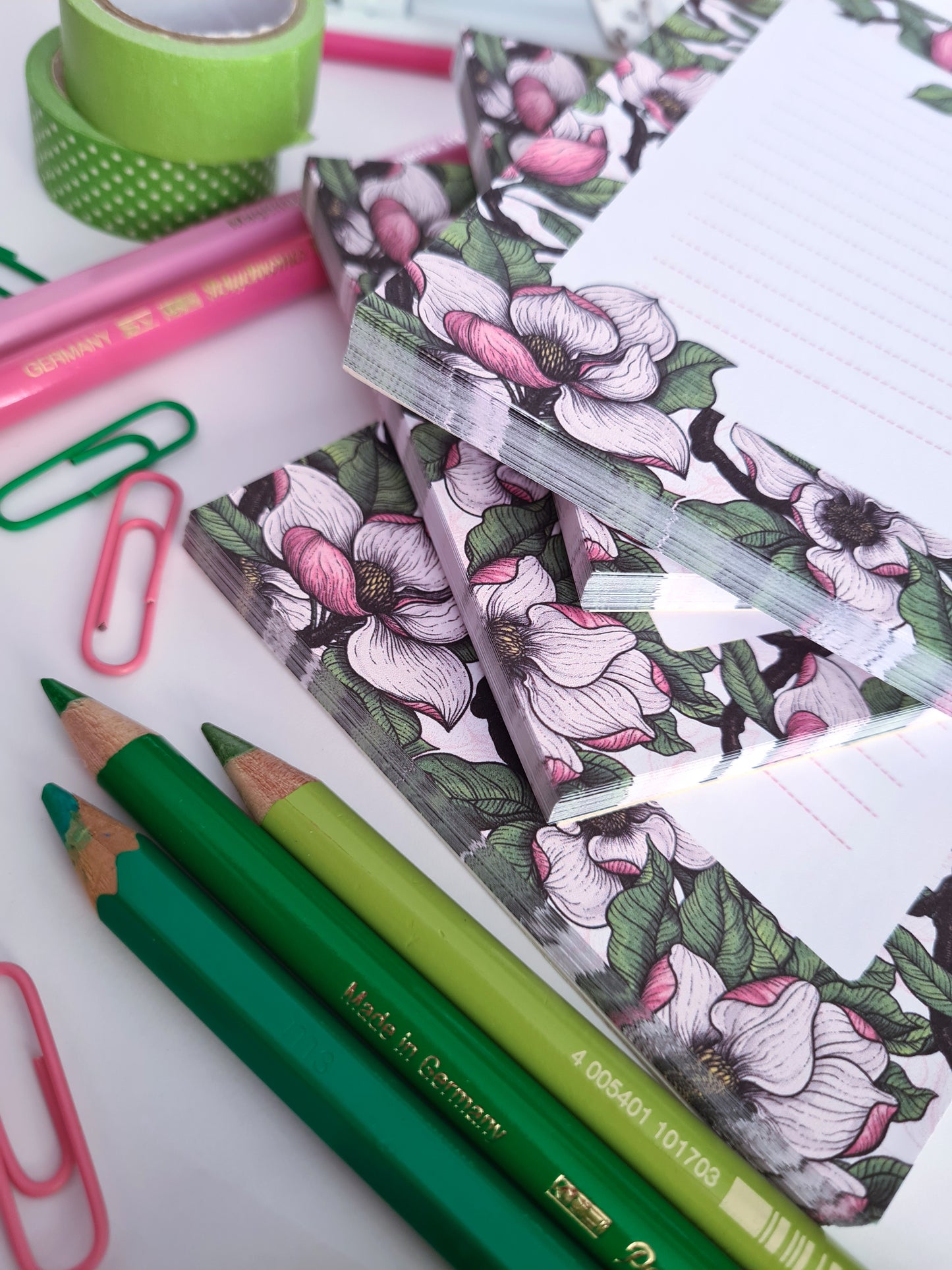 photo of a hand-made notepad illustrated with Magnolia and Chickadee birds