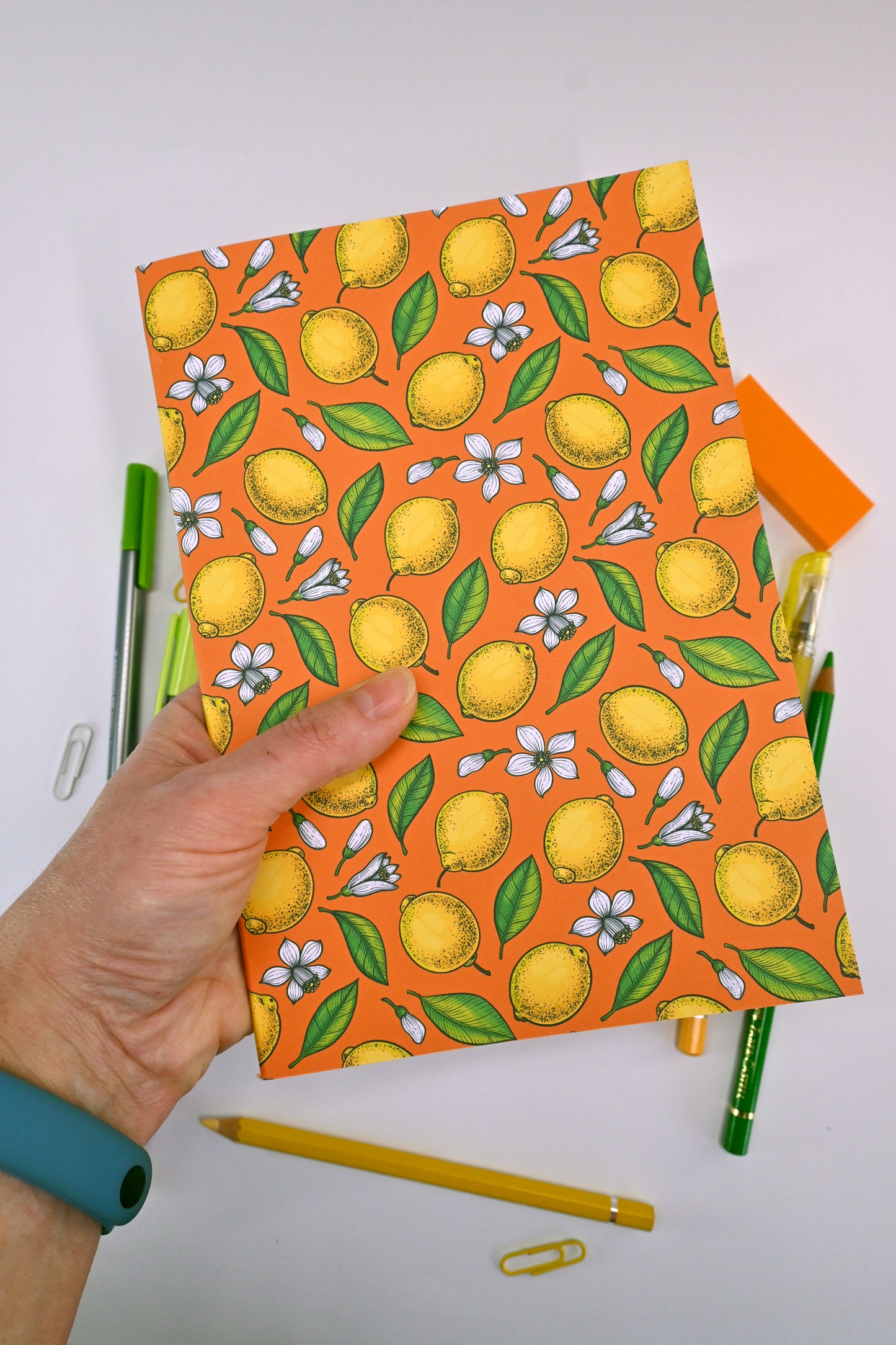 photo of hand-made notebook with hand-painted lemon pattern print on the cover