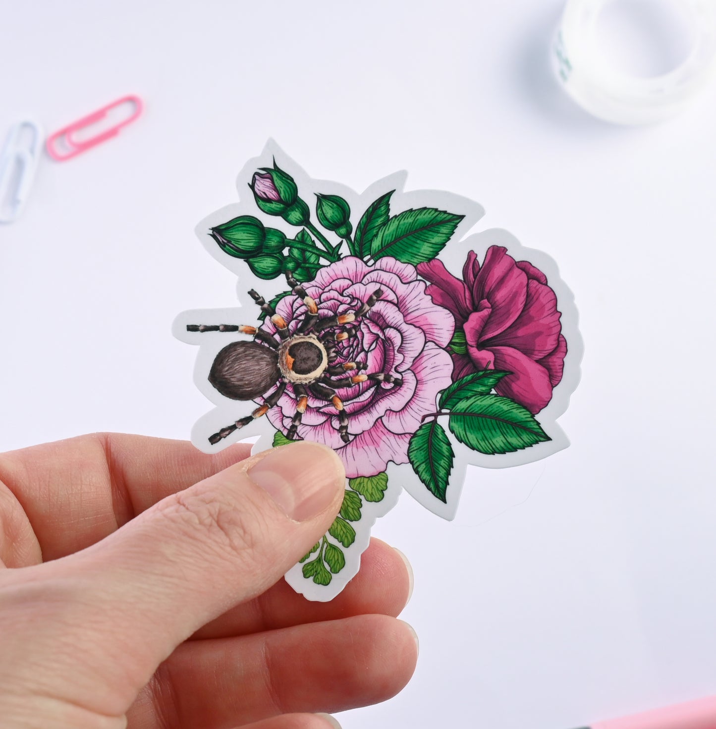 photo of a sticker featuring illustrated bouquet of flowers and tarantula