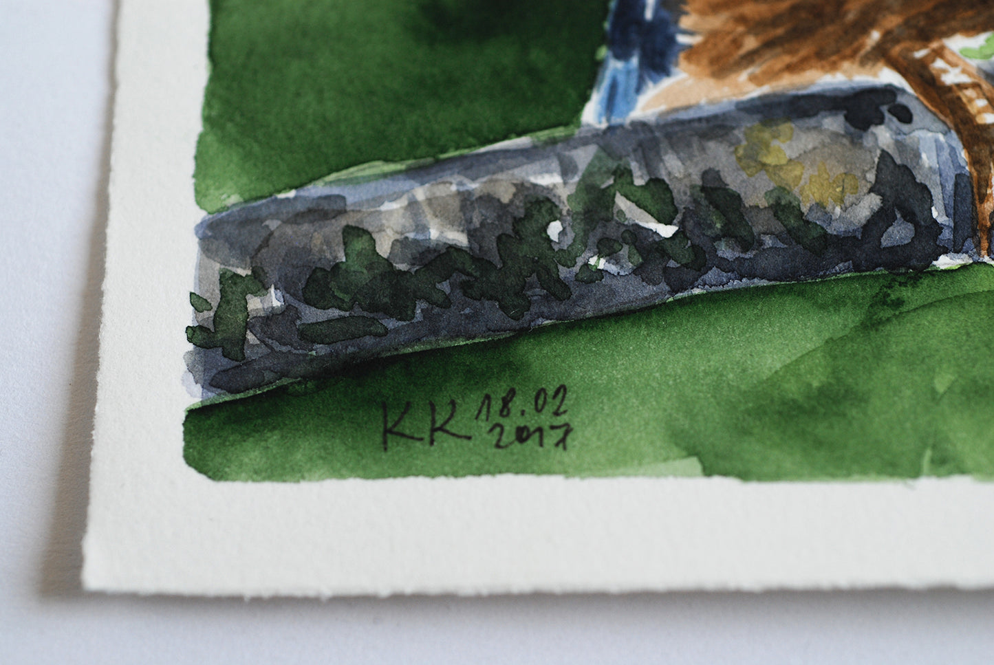Close-up of the corner of a watercolor painting with a signature and date on a white background