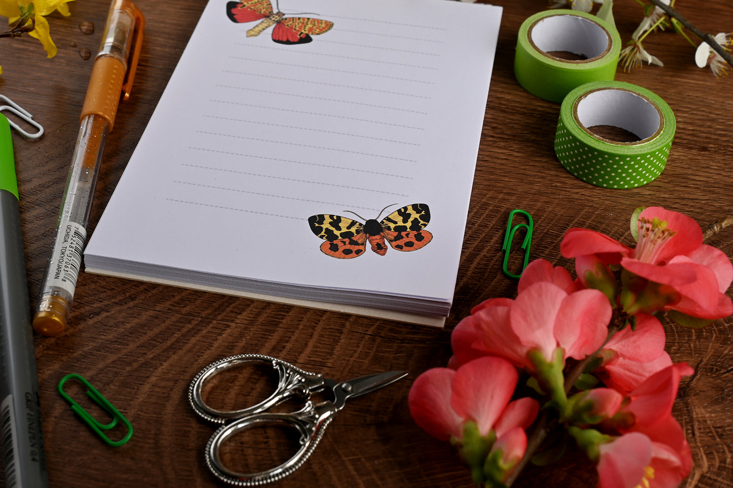 photo featuring a notepad illustrated with 2 moths