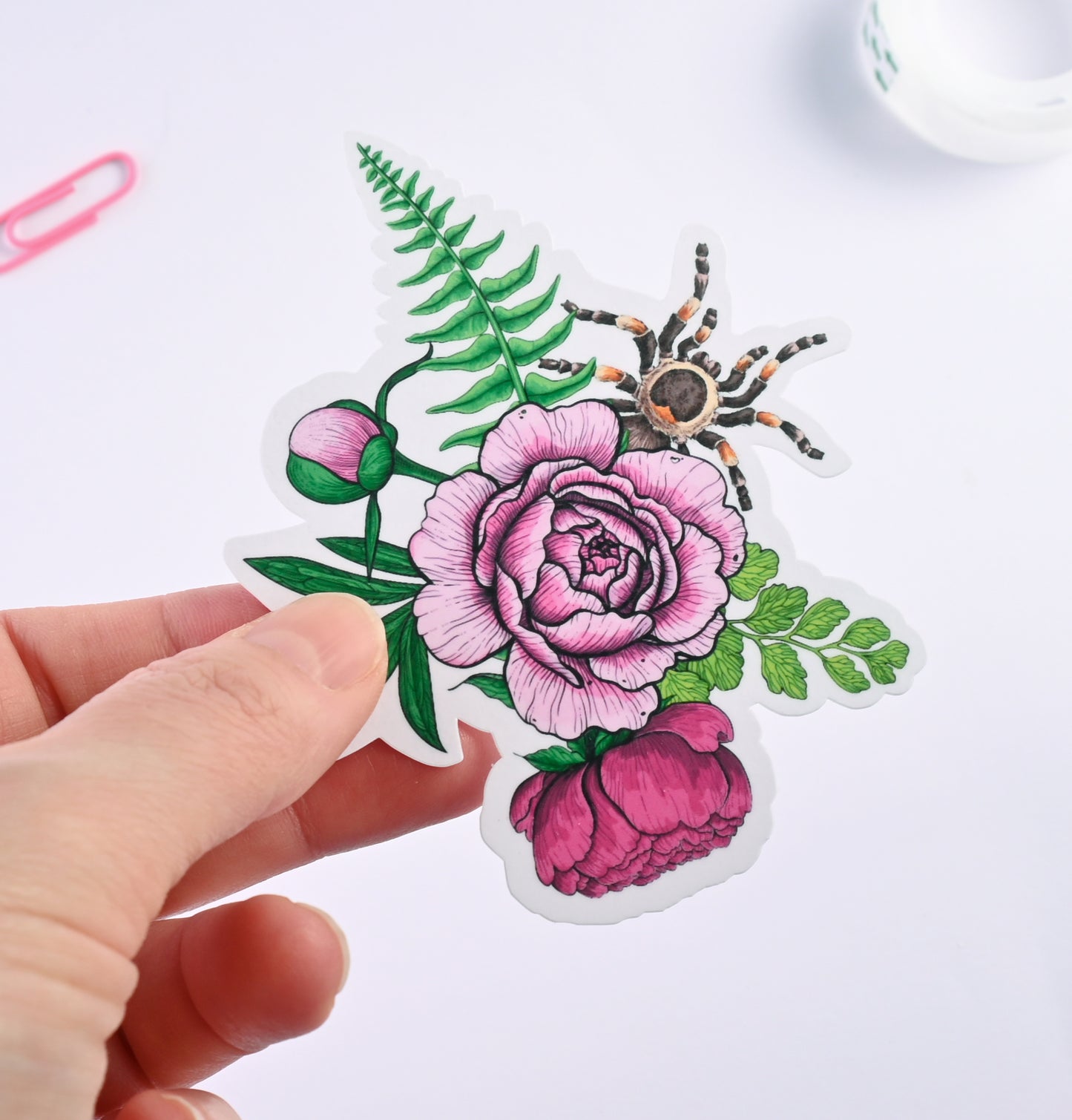 photo of a sticker featuring illustrated bouquet of flowers and tarantula
