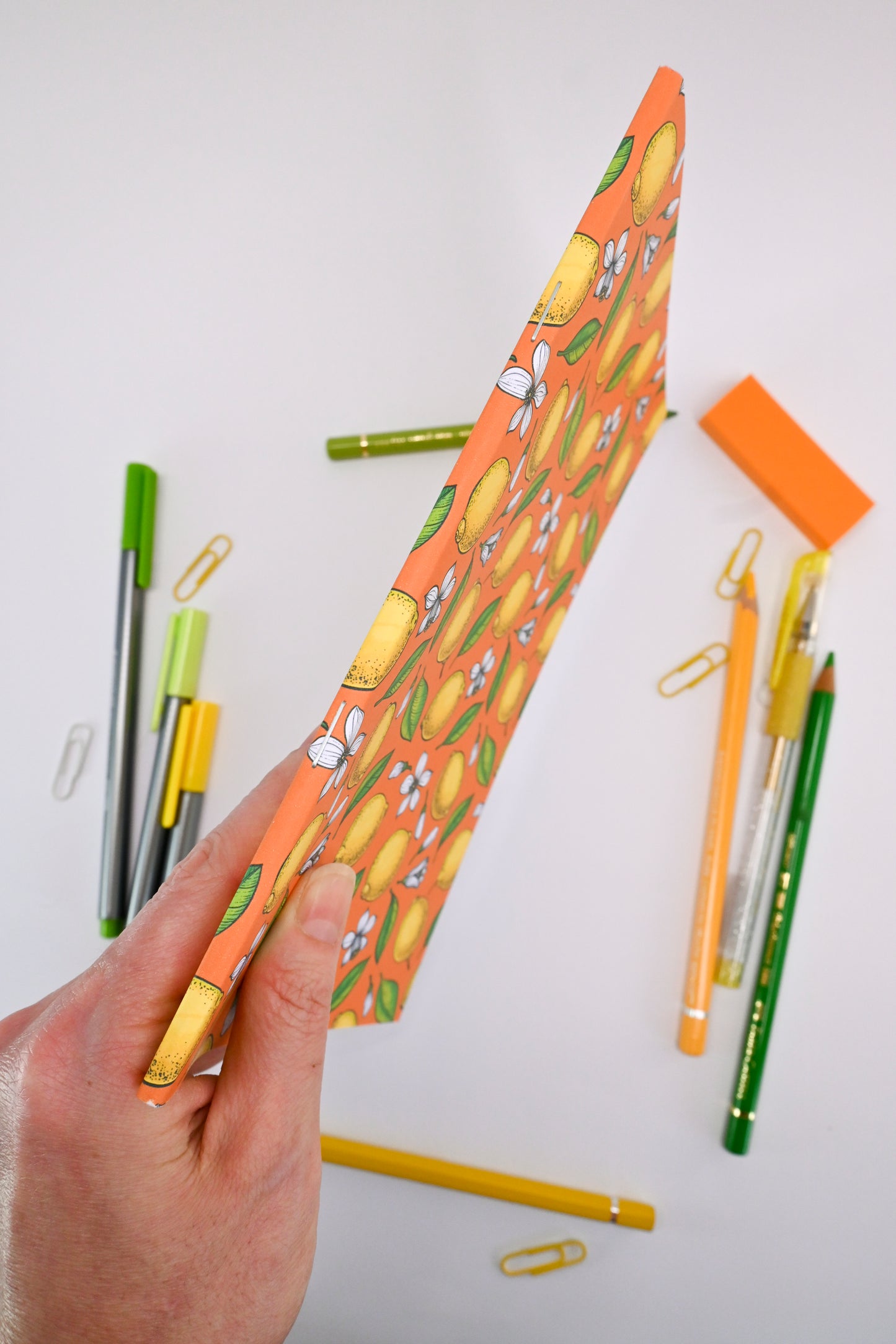 photo of hand-made notebook with hand-painted lemon pattern print on the cover