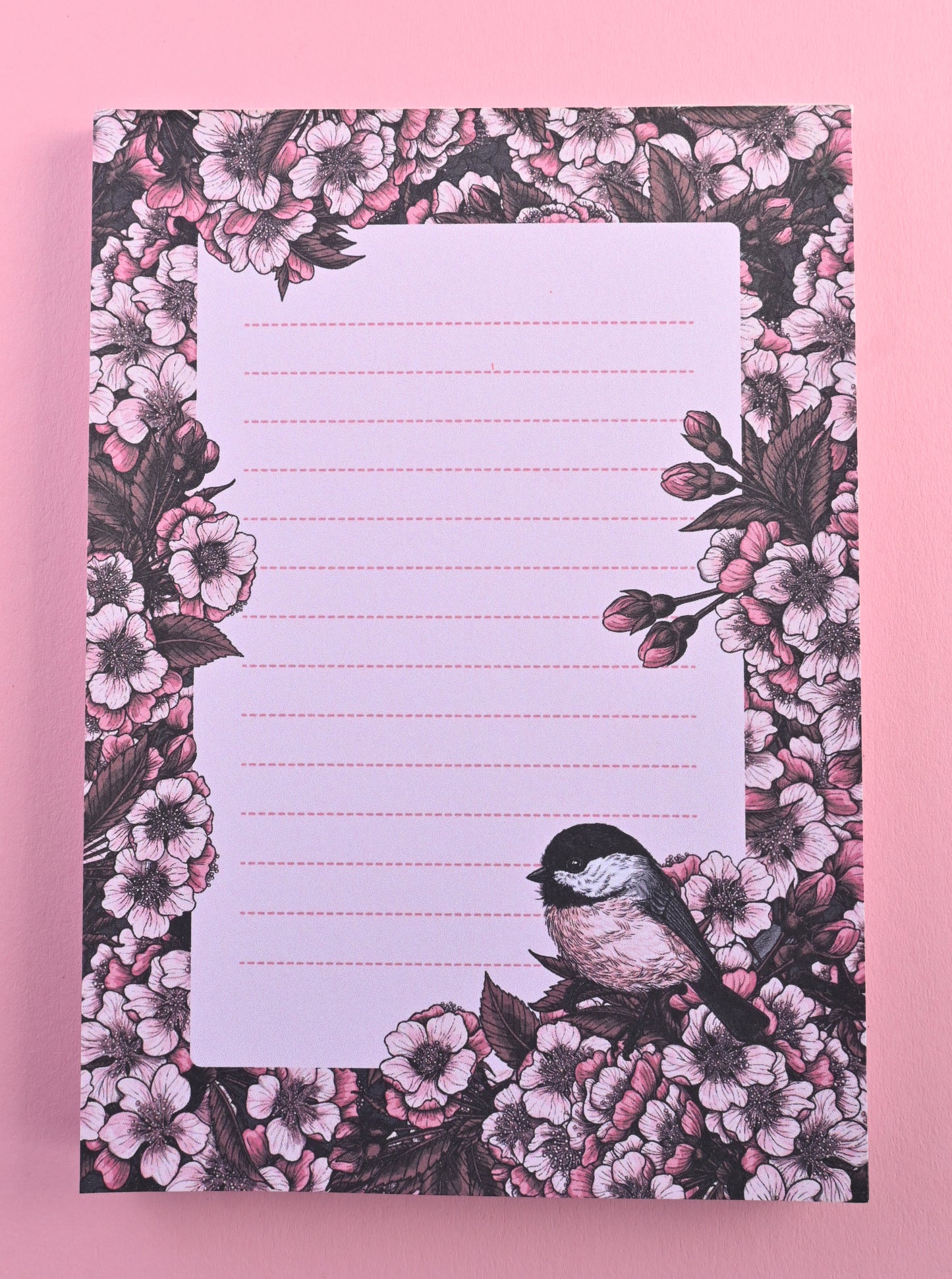 notepad featuring hand painted frame of cherry blosssom and chicakee bird in the lower right corner and lined middle