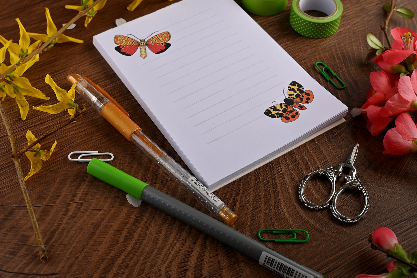 photo featuring a notepad illustrated with 2 moths