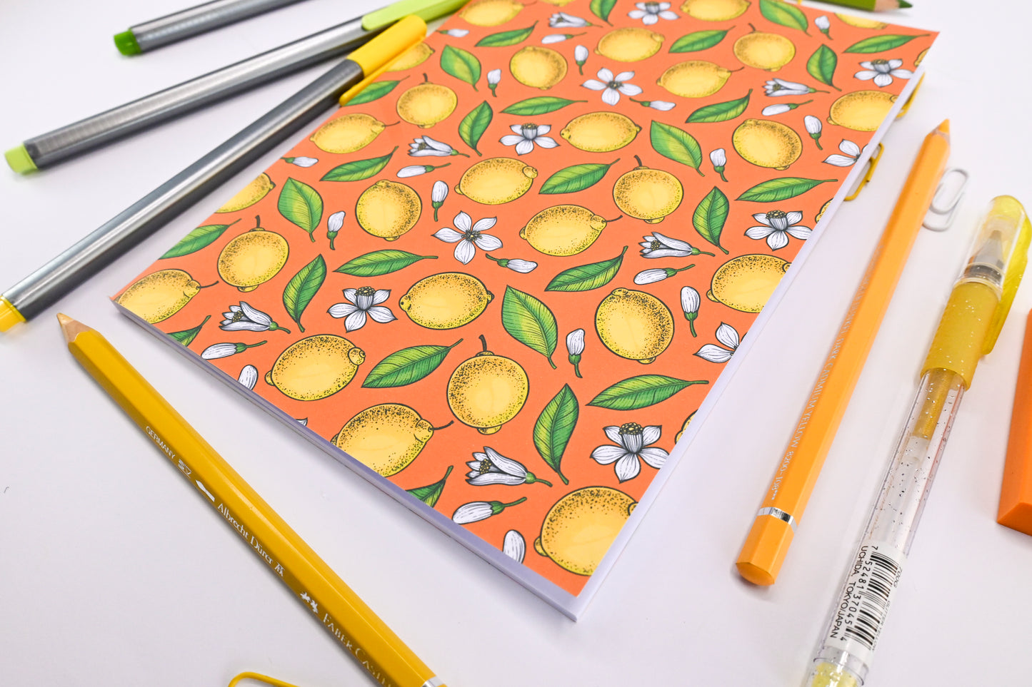 photo of hand-made notebook with hand-painted lemon pattern print on the cover