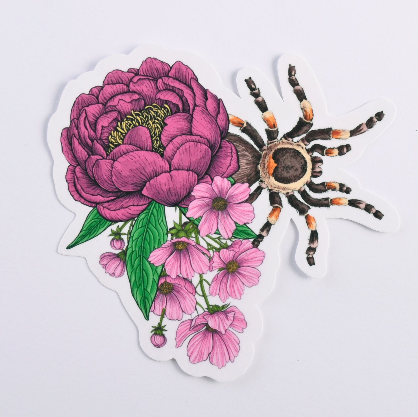 photo of a sticker featuring illustrated bouquet of flowers and tarantula