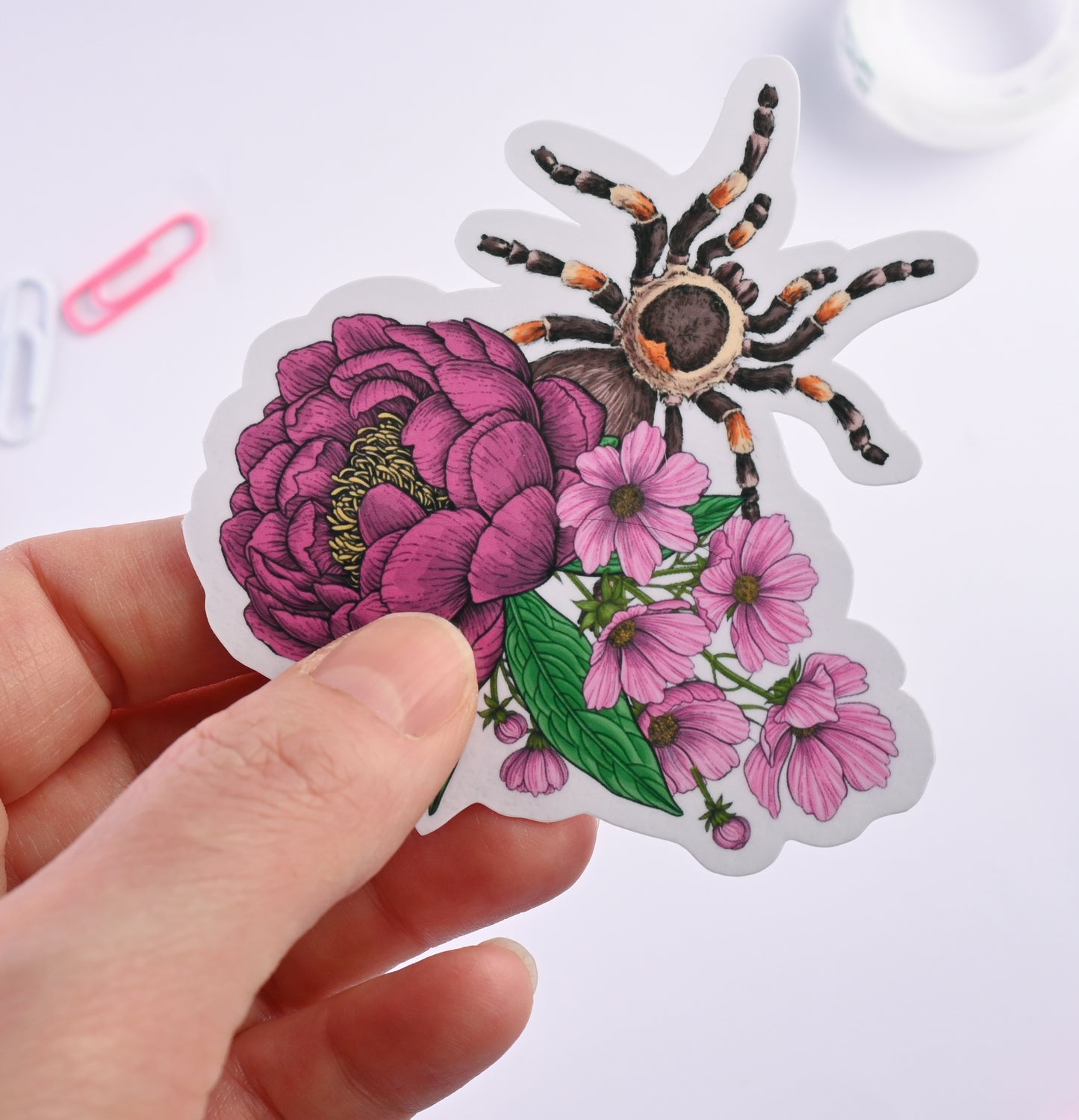 photo of a sticker featuring illustrated bouquet of flowers and tarantula