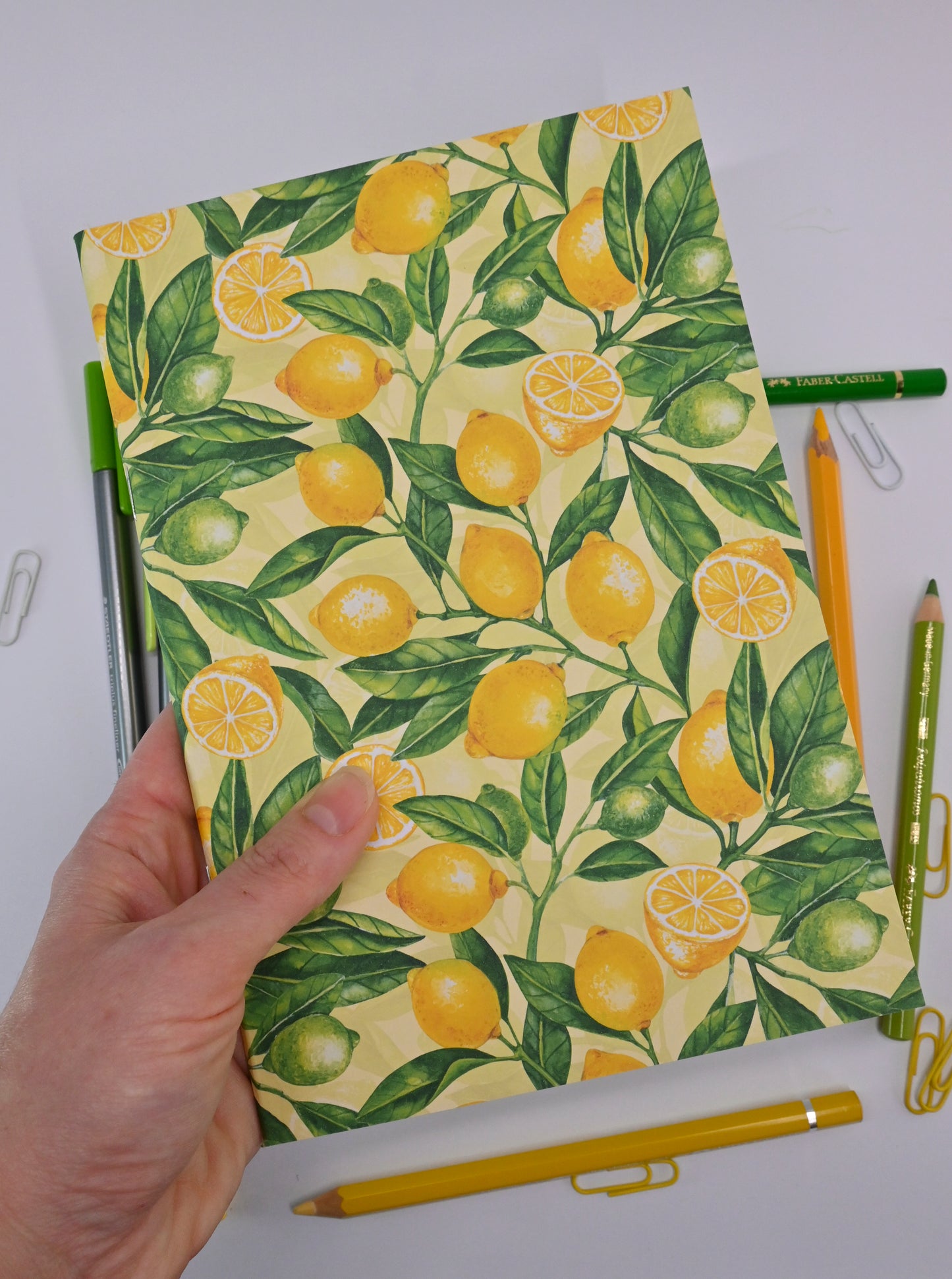 photo of hand-made notebook with hand-painted lemon pattern print on the cover