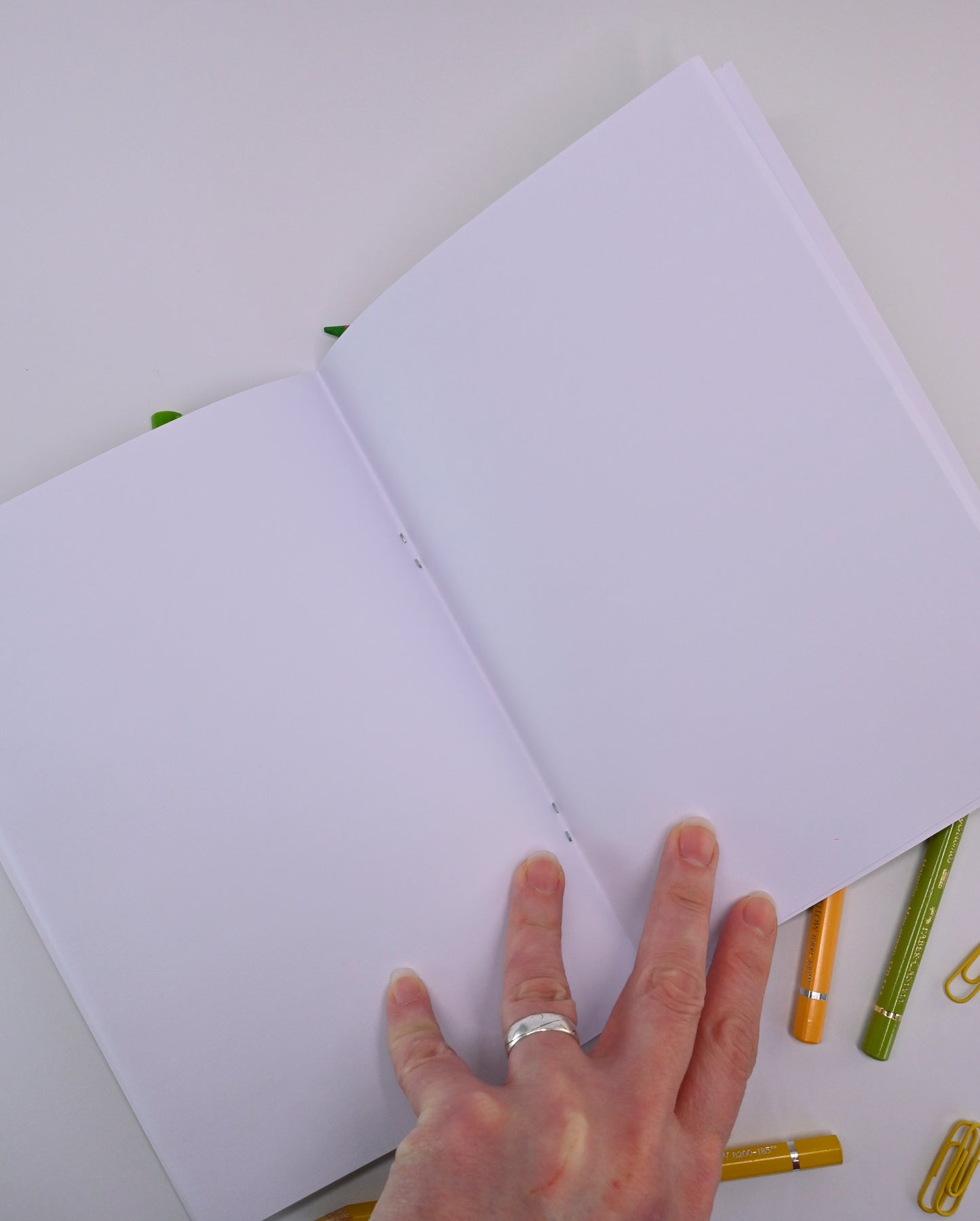 photo of hand-made open notebook with blank white pages