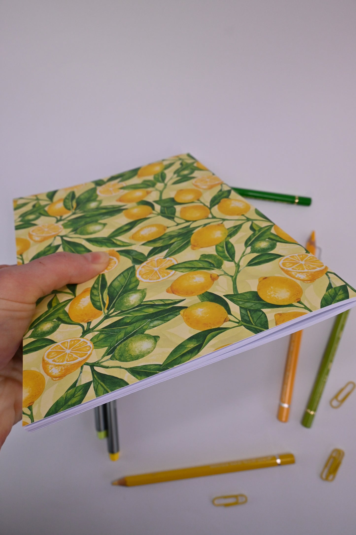 photo of hand-made notebook with hand-painted lemon pattern print on the cover