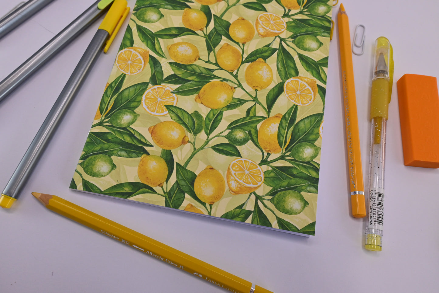 photo of hand-made notebook with hand-painted lemon pattern print on the cover