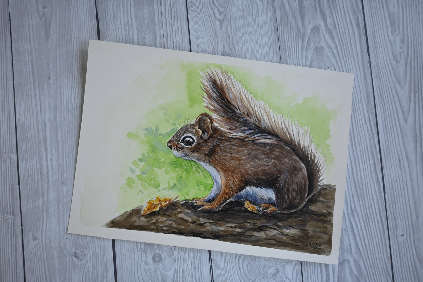 Watercolor painting of a squirrel on a textured surface