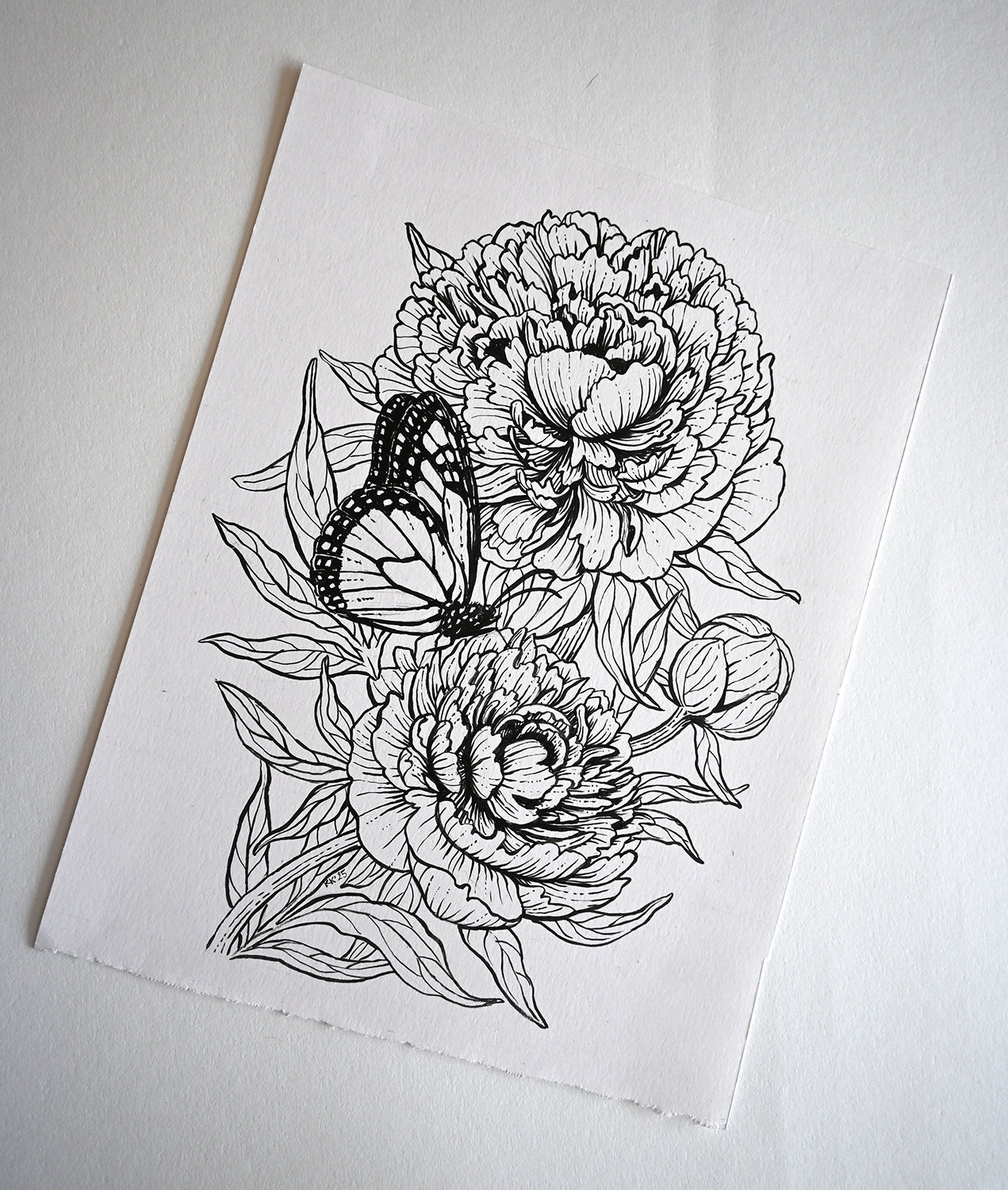 Black line art of flowers and a butterfly on white paper
