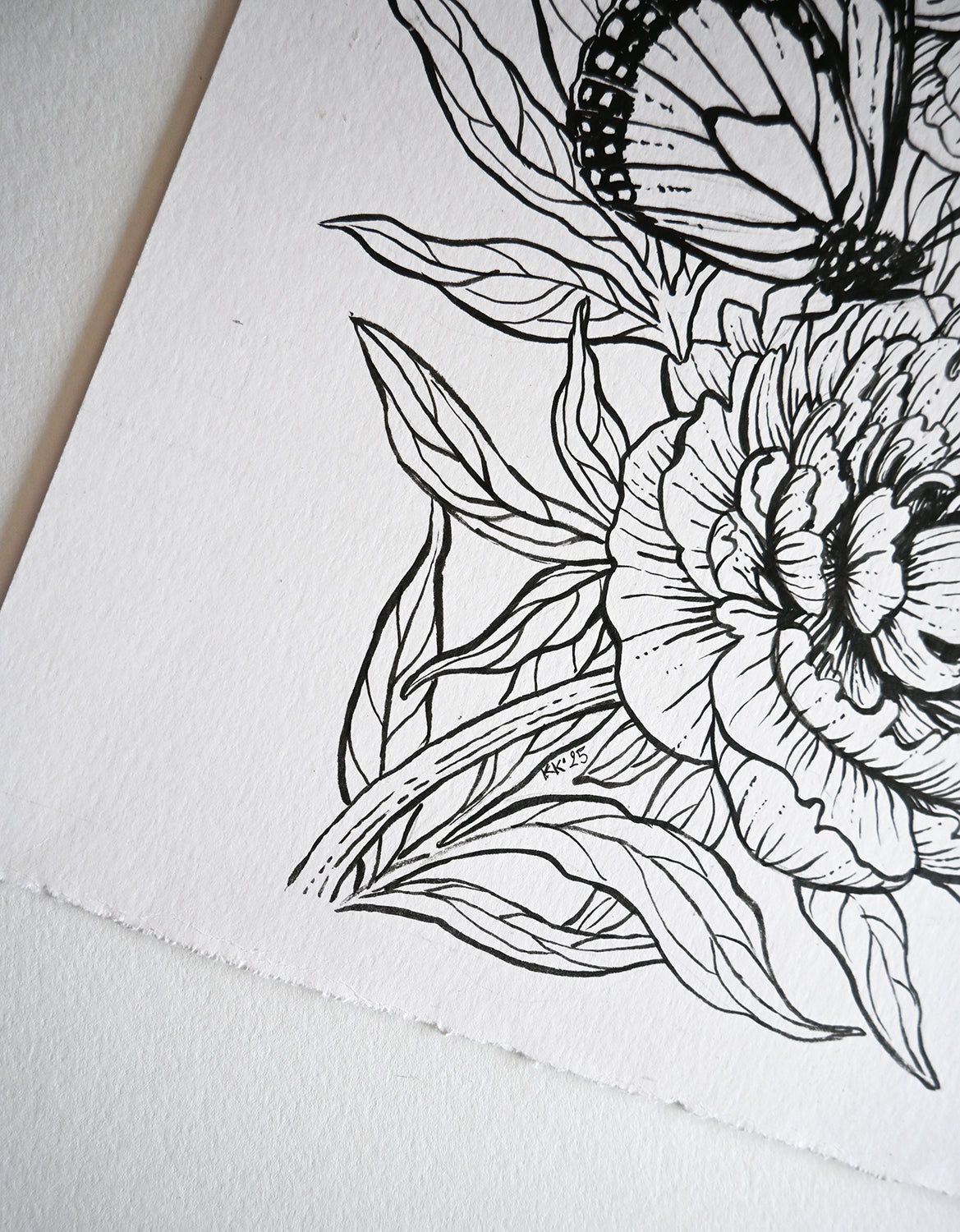 Black line drawing of a flower and butterfly on white paper