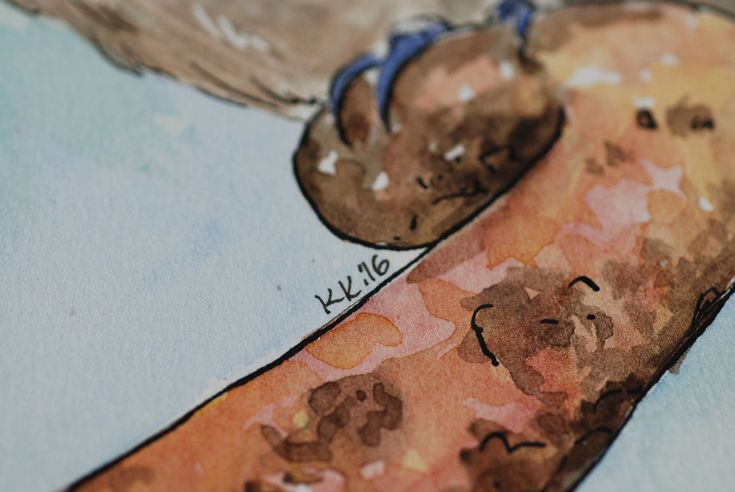 Close-up of a watercolor painting with brown and blue elements on a light blue background.