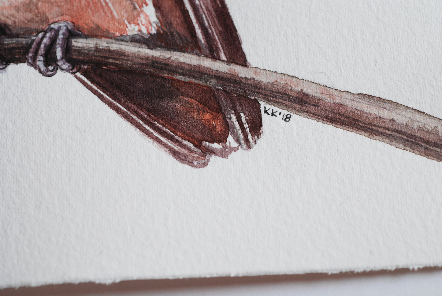 Artistic depiction of a bird perched on a branch with a signature in the corner.