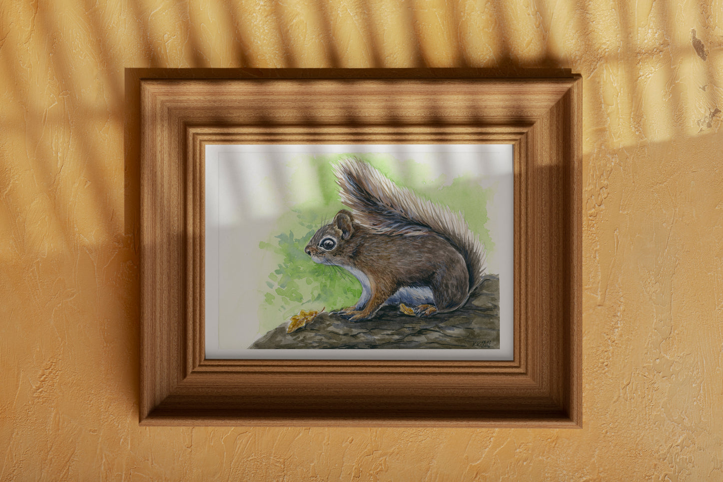 Framed artwork of a squirrel on an orange wall
