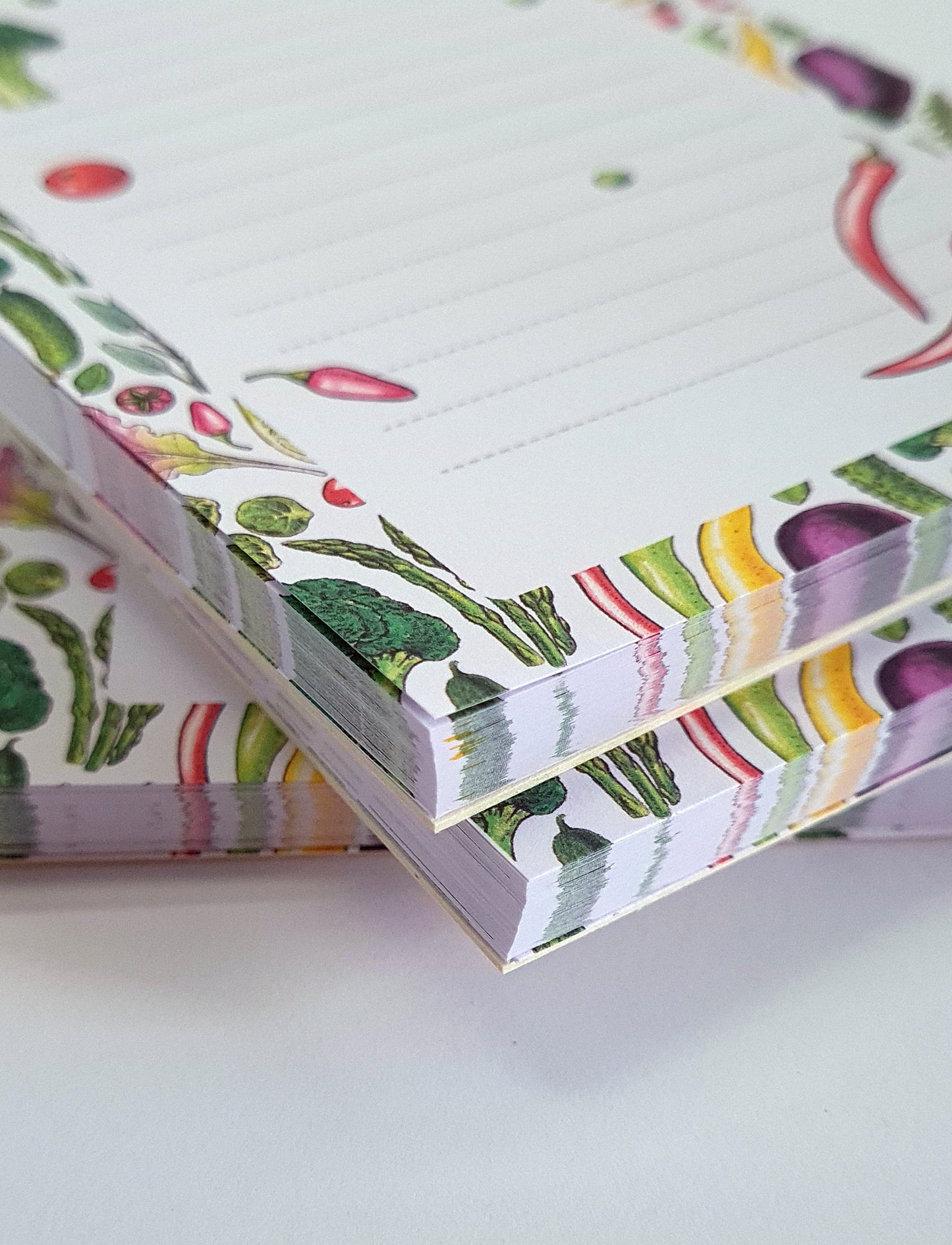 corner close up of a notepad ilustrated with hand-painted with watercolor and ink Vegetables