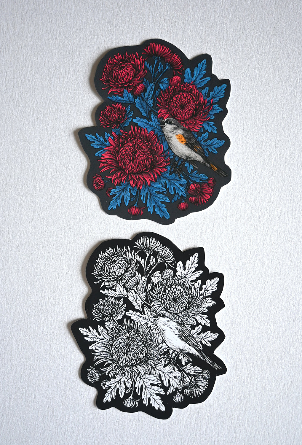 Two vinyl stickers  with chrysanthemum flowers and bird designs on a white background. 