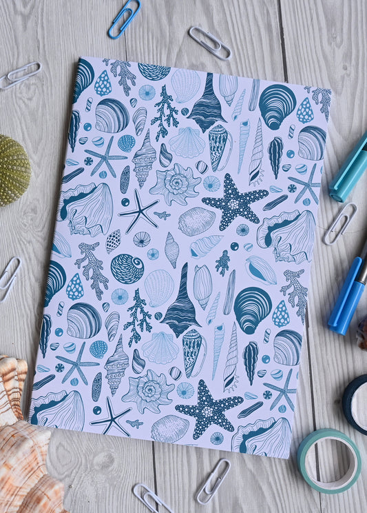 photo of hand-made notebook with hand-painted sea shells pattern print on the cover