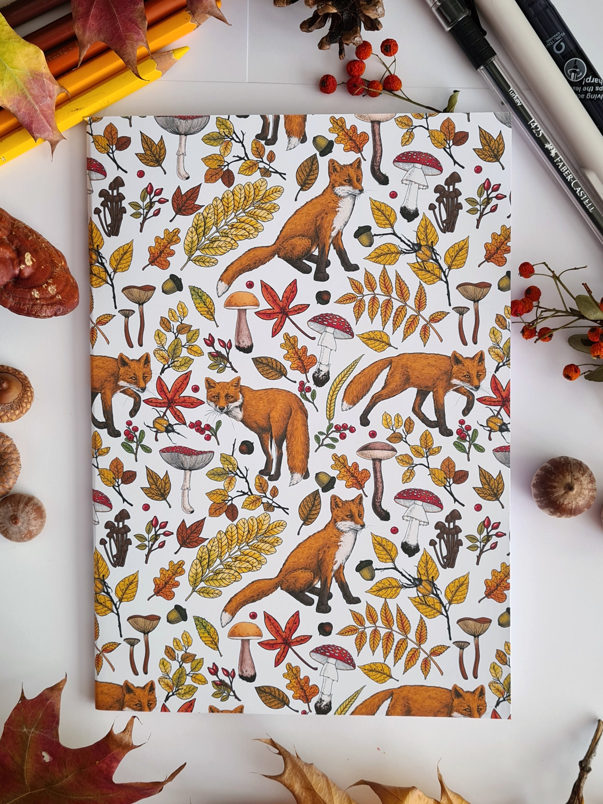 photo of hand-made notebook with hand-painted Autumn Foxes pattern print on the cover