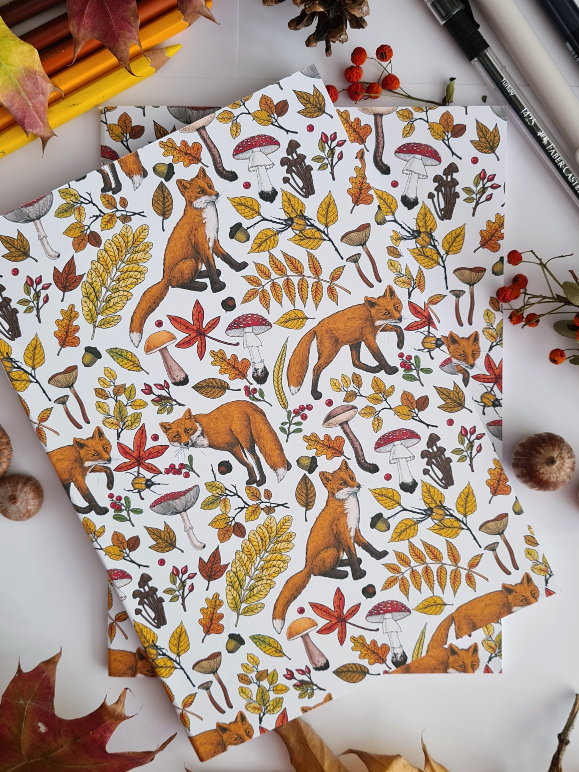 photo of hand-made notebook with hand-painted Autumn Foxes pattern print on the cover