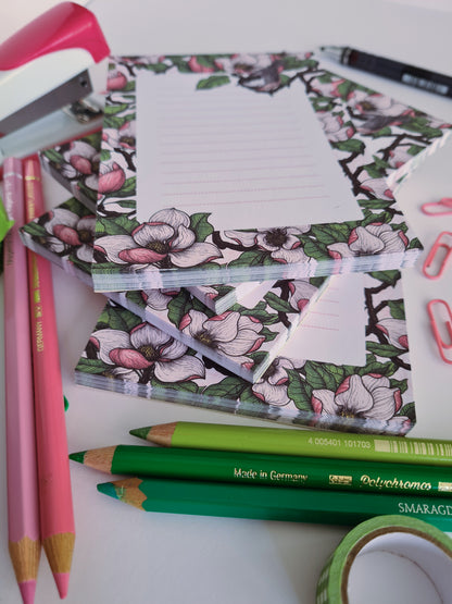 photo of a hand-made notepad illustrated with Magnolia and Chickadee birds 