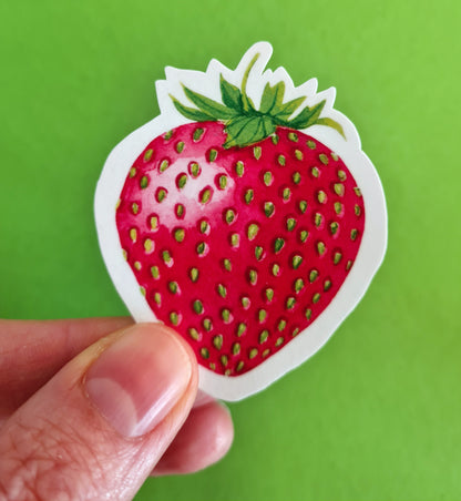 photo of a sticker featuring a strawberry painted with watercolors