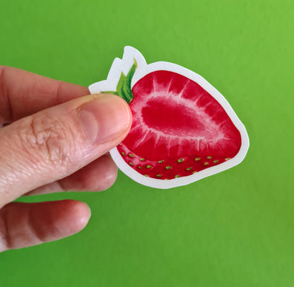 photo of a sticker featuring a strawberry slice painted with watercolors