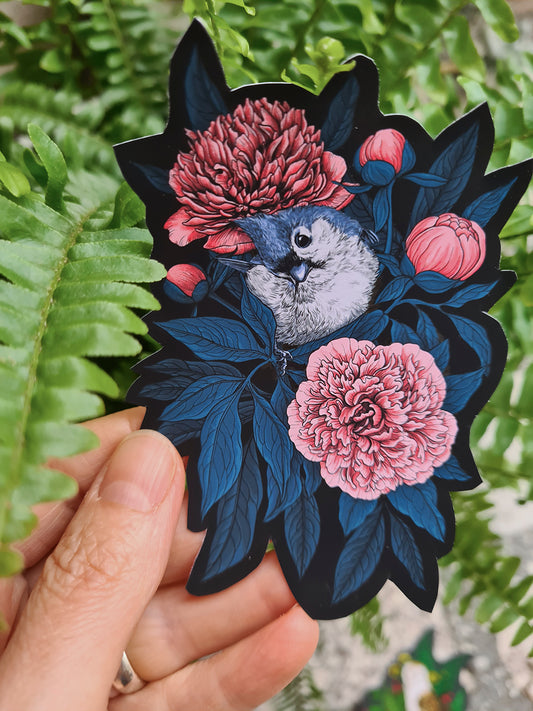 Vinyl sticker with a bird and flowers held against a fern background