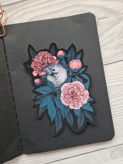 Vinyl sticker with a bird and flowers on a black background
