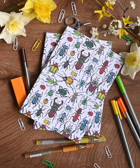 photo of hand-made notebook with hand-painted Beetles pattern print on the cover