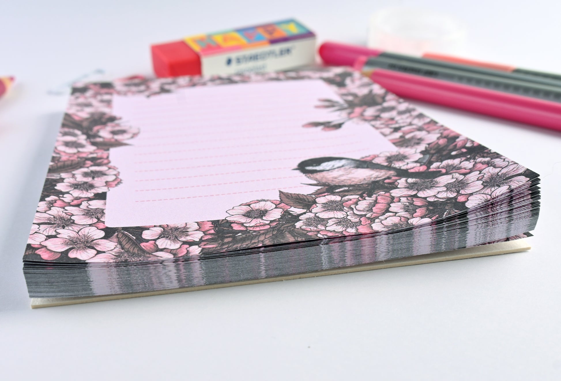 notepad featuring hand painted frame of cherry blosssom and chicakee bird in the lower right corner and  lined middle