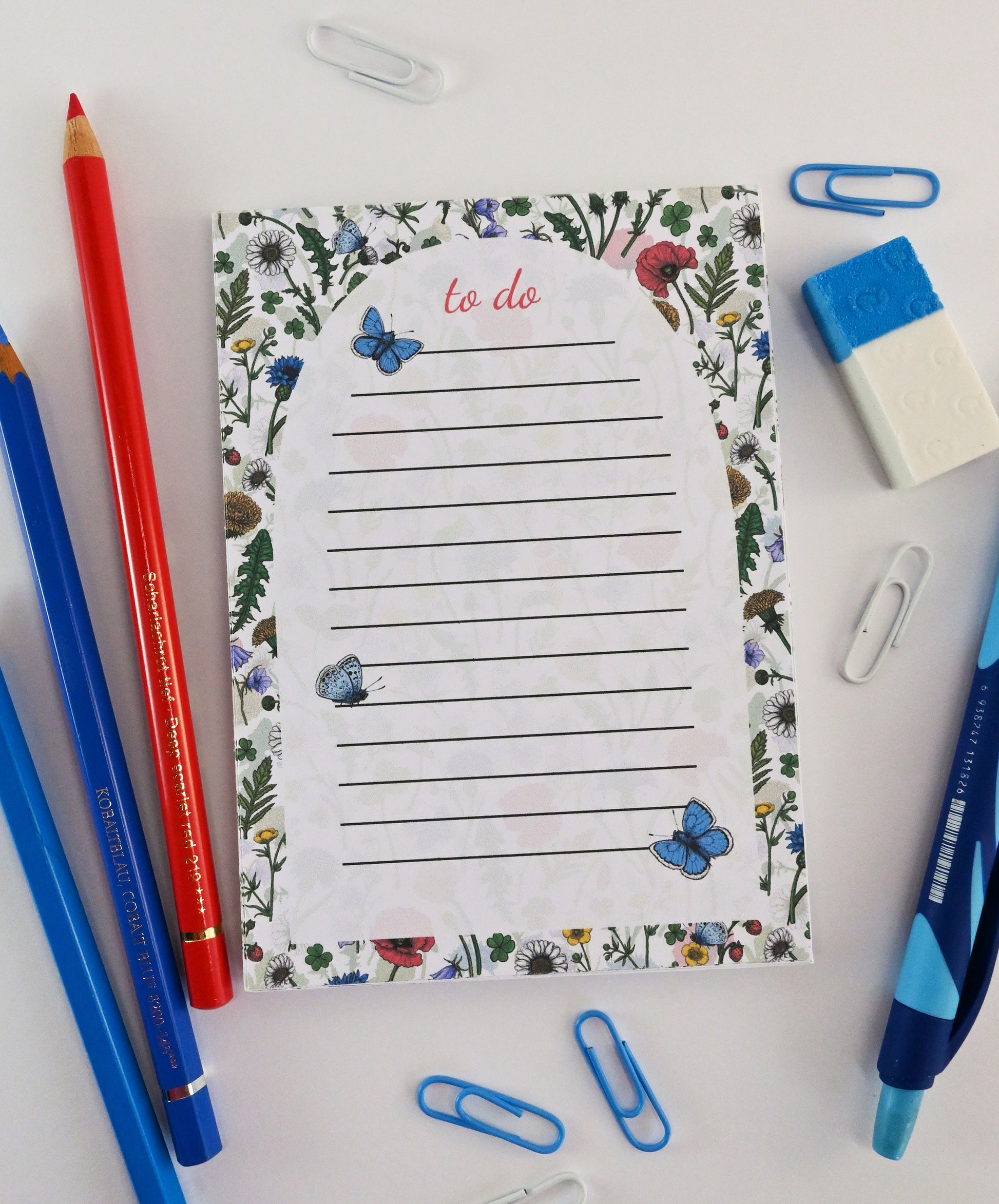 photo featuring a notepad illustrated with wildflowers and butterflies