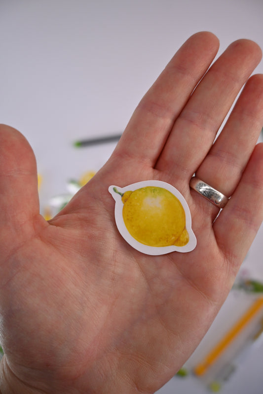 photo of a laminated sticker featuring a lemon painted with watercolors