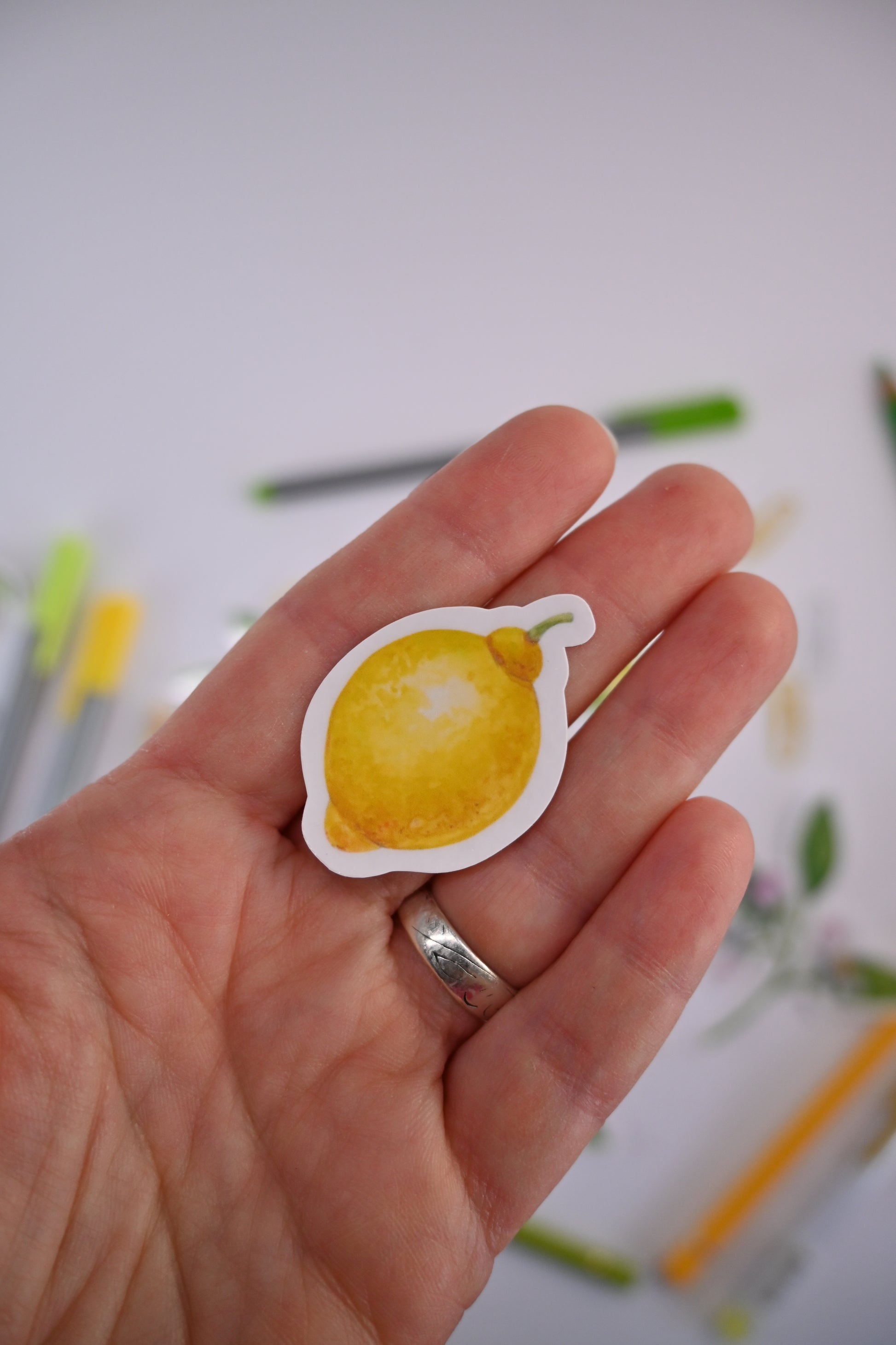 photo of a laminated sticker featuring a lemon painted with watercolors