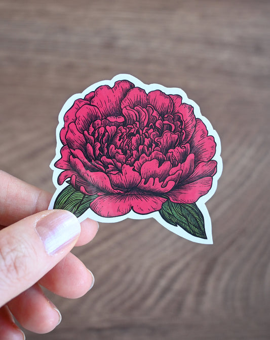 red peony sticker against wooden surace
