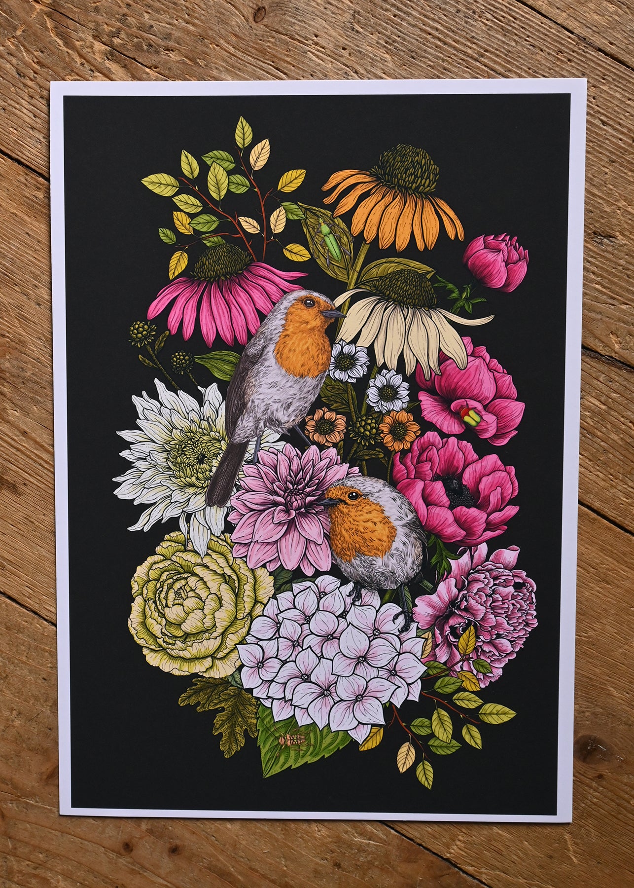  print of an illustration of two robin birds and bouquet of garden flowers on a wooden surface