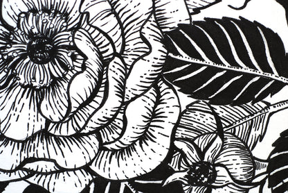 Black and white floral illustration with detailed leaves and petals.