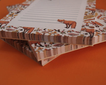 close up of notepads ilustrated with hand-painted red Foxes and autumn flora