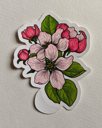 Sticker with apple blossoms and leaves in pink and green  on a white background