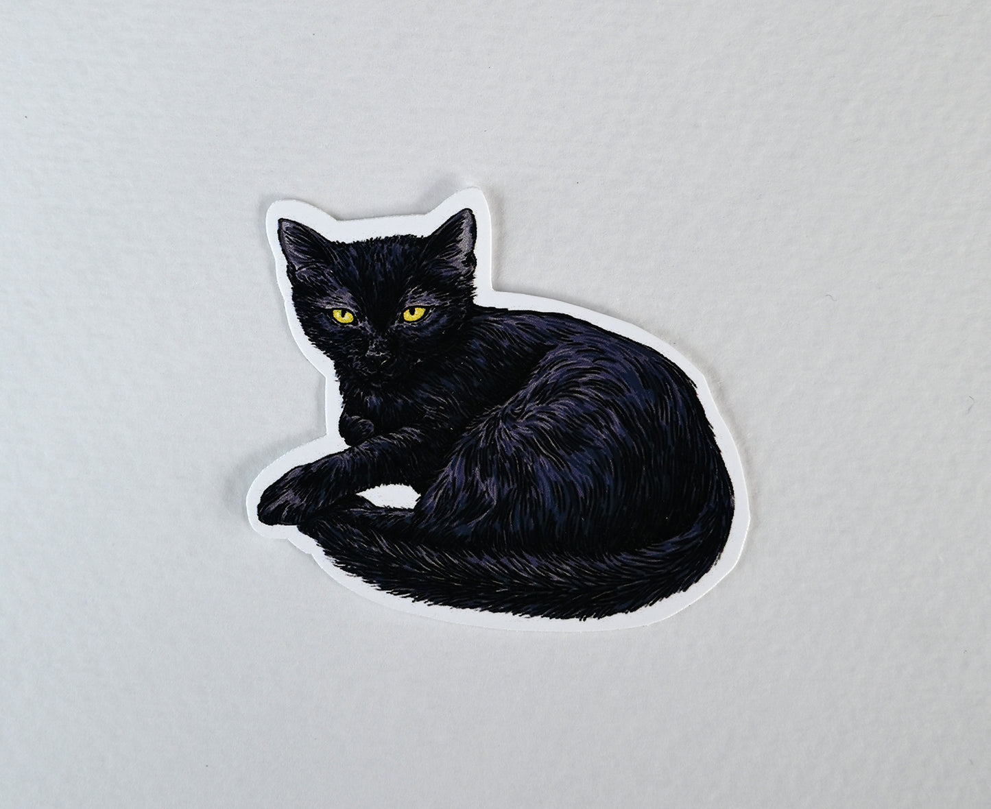 Black cat-shaped sticker on a white background