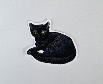 Black cat-shaped sticker on a white background