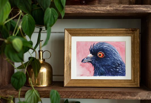 Framed artwork of a pigeon on a wooden shelf with plants and a gold bottle.