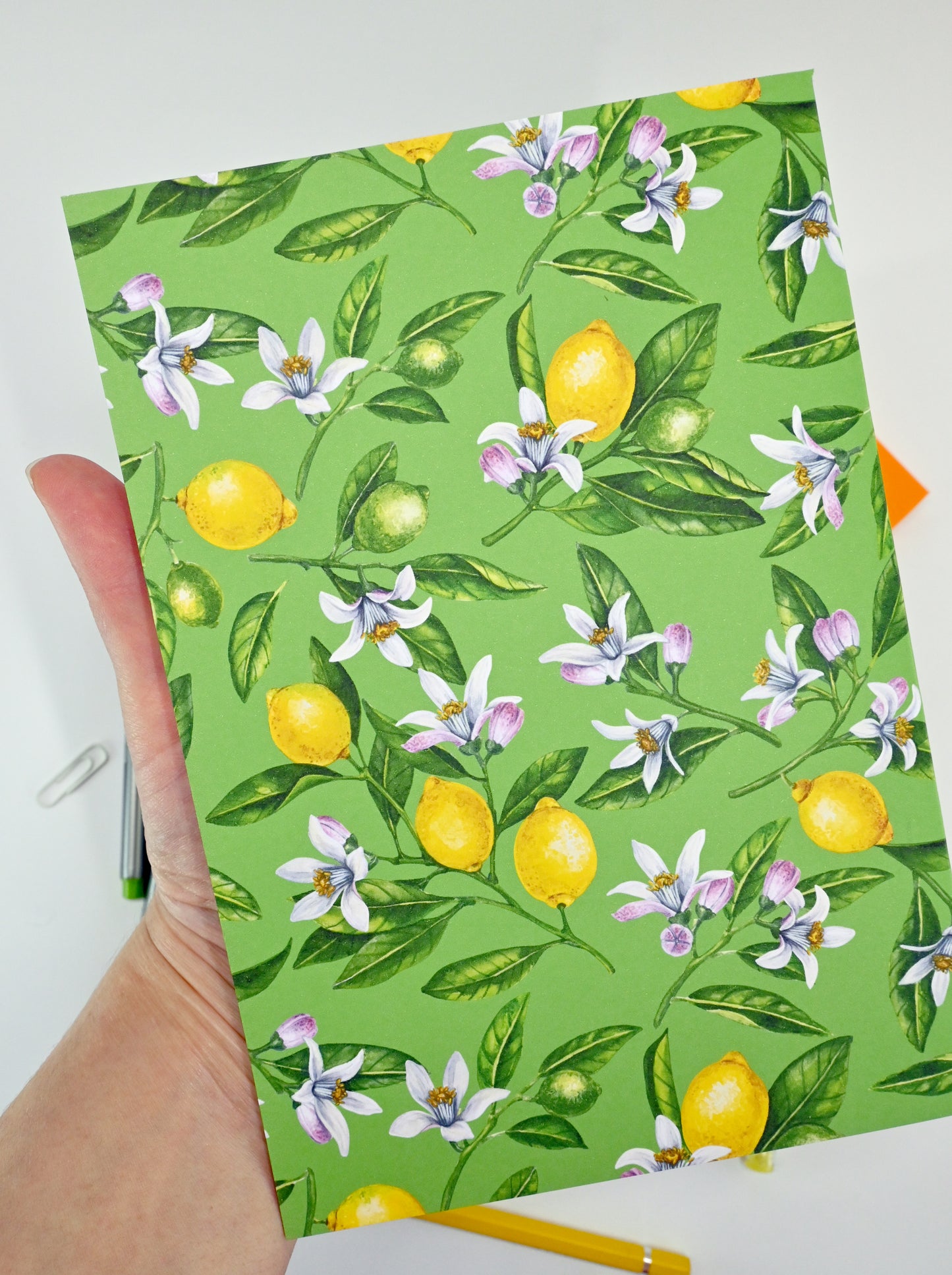 photo of hand-made notebook with hand-painted lemon pattern print on the cover