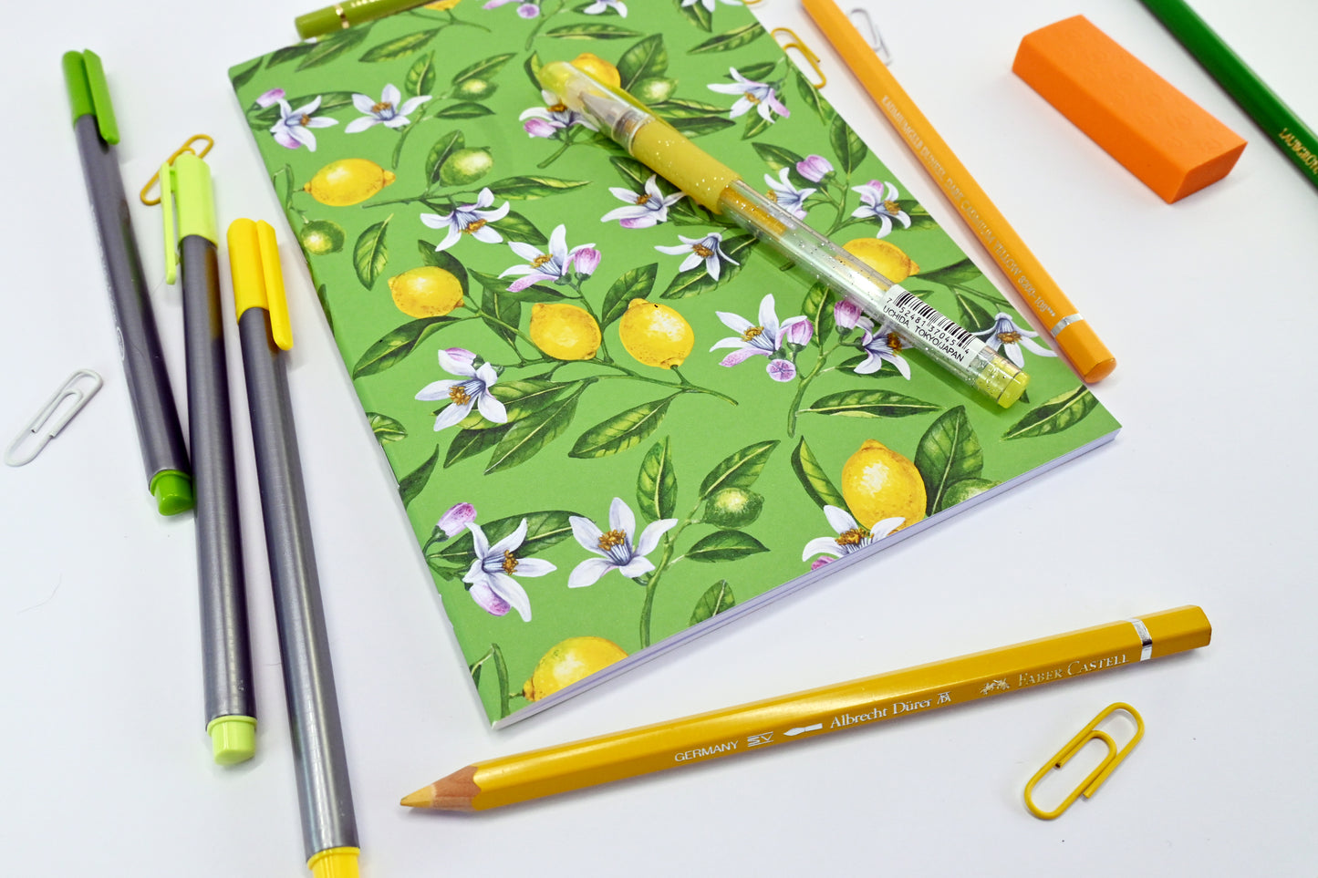 photo of hand-made notebook with hand-painted lemon pattern print on the cover